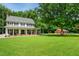 Beautiful two-story house with a red barn and a well-manicured front lawn at 633 Fleming Rd, Youngsville, NC 27596