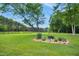 Beautifully landscaped grounds with a flowerbed and large trees at 633 Fleming Rd, Youngsville, NC 27596