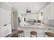 Bright kitchen with white cabinetry, granite countertops, stainless steel appliances, and a breakfast bar at 633 Fleming Rd, Youngsville, NC 27596