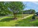 Scenic landscape with a mature tree, black fencing, and lush green grass at 633 Fleming Rd, Youngsville, NC 27596