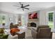 Inviting living room with a brick fireplace, ceiling fan, lots of light, and cozy seating at 633 Fleming Rd, Youngsville, NC 27596