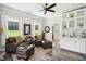 Bright living room featuring hardwood floors, plantation shutters, comfortable furniture, and ample natural light at 633 Fleming Rd, Youngsville, NC 27596
