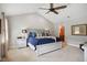 Vaulted main bedroom with a ceiling fan and adjoining bathroom at 633 Fleming Rd, Youngsville, NC 27596