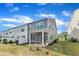 A home's backyard features a screened-in porch with a well-maintained lawn area and blue sky above at 6549 Tremolo Trl, Raleigh, NC 27616
