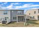 View of a home's back exterior showcasing a screened-in porch and a small lawn area at 6549 Tremolo Trl, Raleigh, NC 27616
