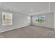 Spacious bedroom with large windows and tray ceiling at 6549 Tremolo Trl, Raleigh, NC 27616