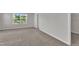 Bright bedroom with carpet, window, and closet at 6549 Tremolo Trl, Raleigh, NC 27616