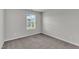 Empty bedroom featuring carpet and a window with neutral paint at 6549 Tremolo Trl, Raleigh, NC 27616