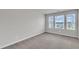 Bright bedroom with three windows and neutral carpet at 6549 Tremolo Trl, Raleigh, NC 27616