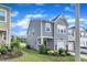 Stylish two-story home with a one car garage, green lawn, and attractive stone accents at 6549 Tremolo Trl, Raleigh, NC 27616