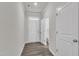 Bright entryway with white walls, wood-look floors, and access to the powder room at 6549 Tremolo Trl, Raleigh, NC 27616