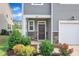 Inviting front entrance with a brick accent, landscaping, and a covered porch. Welcome Home! at 6549 Tremolo Trl, Raleigh, NC 27616