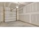 Empty garage space featuring garage door mechanisms and unfinished walls at 6549 Tremolo Trl, Raleigh, NC 27616