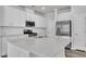 Modern kitchen showcasing white cabinets, stainless steel appliances, and a center island at 6549 Tremolo Trl, Raleigh, NC 27616