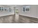 Bright living room boasts natural light, hardwood flooring, and a sliding glass door to the yard at 6549 Tremolo Trl, Raleigh, NC 27616