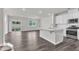 Open-concept living room and kitchen, with modern countertops, stainless steel appliances, and backyard access at 6549 Tremolo Trl, Raleigh, NC 27616
