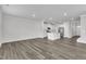 Open-concept living space flows into a modern kitchen with stainless steel appliances and an island at 6549 Tremolo Trl, Raleigh, NC 27616