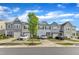 Townhome street view showcasing well-maintained lawns and attractive exteriors. Perfect for community living at 6549 Tremolo Trl, Raleigh, NC 27616