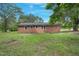 Back exterior of a brick house featuring a wide yard and classic architectural details at 658 Love Grove Church Rd, Sanford, NC 27332