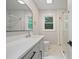 Modern bathroom featuring a large vanity, stylish mirror, and a tiled walk-in shower at 658 Love Grove Church Rd, Sanford, NC 27332