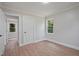 This bedroom features vinyl floors, a window for natural light, and a view into another room at 658 Love Grove Church Rd, Sanford, NC 27332