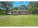 Charming brick home featuring a spacious front yard, complemented by mature trees and a welcoming facade at 658 Love Grove Church Rd, Sanford, NC 27332