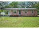 Beautiful brick home with fresh landscaping and covered porch, enhancing its curb appeal at 658 Love Grove Church Rd, Sanford, NC 27332