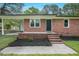 Inviting brick front porch features a covered area and new landscaping around the entrance at 658 Love Grove Church Rd, Sanford, NC 27332