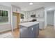 Stylish kitchen featuring an island, stainless appliances, and elegant gray cabinetry with modern hardware at 658 Love Grove Church Rd, Sanford, NC 27332