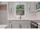 Close-up of the kitchen sink and countertops in a contemporary and freshly remodeled kitchen at 658 Love Grove Church Rd, Sanford, NC 27332