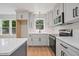 The kitchen features white cabinets, stainless appliances, sleek hardware, and quartz countertops at 658 Love Grove Church Rd, Sanford, NC 27332