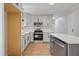 Updated kitchen featuring white cabinets, stainless steel appliances, and a stylish island with quartz countertops at 658 Love Grove Church Rd, Sanford, NC 27332