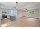 Bright, open living room with modern lighting, stainless appliances, and new hardwood floors at 658 Love Grove Church Rd, Sanford, NC 27332