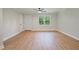 Bright living room boasts beautiful wood floors, fresh paint, and ample natural light from large windows at 658 Love Grove Church Rd, Sanford, NC 27332