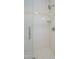 Tiled walk-in shower with seamless glass door and modern fixtures at 658 Love Grove Church Rd, Sanford, NC 27332