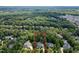 Aerial view of the property surrounded by mature trees in a neighborhood at 709 Skymont Dr, Holly Springs, NC 27540