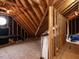 Unfinished attic space showing the structural support with exposed wood beams and a round window at 709 Skymont Dr, Holly Springs, NC 27540
