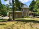 Backyard featuring a screened in porch and green lawn surrounded by mature trees and tasteful landscaping at 709 Skymont Dr, Holly Springs, NC 27540