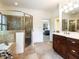 Bathroom featuring a glass walk-in shower, and a stylish vanity with double sinks at 709 Skymont Dr, Holly Springs, NC 27540