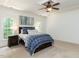 Bedroom with stylish coffered ceiling, ceiling fan, and neutral paint, featuring coordinated bedding at 709 Skymont Dr, Holly Springs, NC 27540