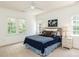 Cozy bedroom featuring double windows for ample light, coordinated decor, and neutral walls at 709 Skymont Dr, Holly Springs, NC 27540