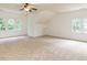 Spacious carpeted bonus room with a ceiling fan and lots of natural light from the many windows at 709 Skymont Dr, Holly Springs, NC 27540