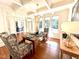Sunlit dining room boasts hardwood floors, large windows, and a stylish table setting for everyday enjoyment at 709 Skymont Dr, Holly Springs, NC 27540