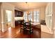 Charming dining area with hardwood floors, shuttered windows, and built-in buffet and window bench at 709 Skymont Dr, Holly Springs, NC 27540