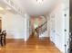 Inviting foyer with gleaming hardwood floors and a staircase to the upper level at 709 Skymont Dr, Holly Springs, NC 27540