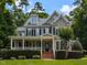 Charming two-story home with a covered front porch and manicured landscaping at 709 Skymont Dr, Holly Springs, NC 27540