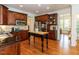 Well-equipped kitchen with dark wood cabinets, granite countertops, and stainless steel appliances at 709 Skymont Dr, Holly Springs, NC 27540