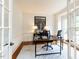 Bright office with a modern desk, neutral rug, and French doors at 709 Skymont Dr, Holly Springs, NC 27540