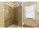 Bathroom with tiled walls, tub, shower, toilet, and patterned wallpaper and flooring at 7620 Harps Mill Rd, Raleigh, NC 27615