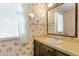 Bathroom with a vanity, round sink and flower patterned wall paper at 7620 Harps Mill Rd, Raleigh, NC 27615